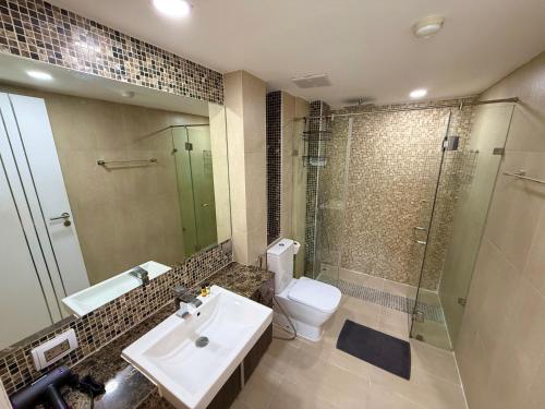 a bathroom with a sink and a shower and a toilet at Large luxury condo - Pattaya City Centre - Centara Avenue, Pool View - 805 in Pattaya Central