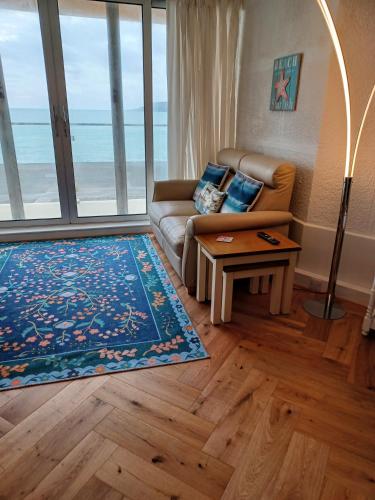a living room with a couch and a coffee table at Ocean View in Cawsand