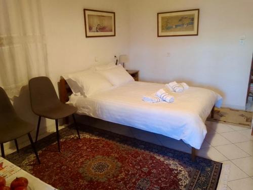 a bedroom with two beds with towels on them at Dimitra's traditional house in Katarráktis