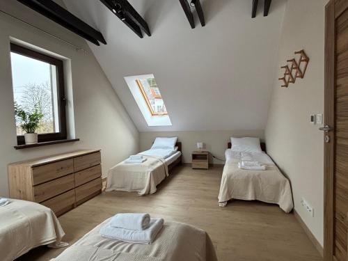 a room with two beds and a window at Janowa Góra 9A in Sienna