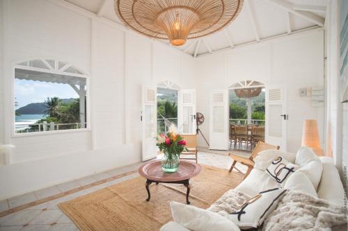 a living room with a couch and a table at Villa M'Bay in Sainte-Marie