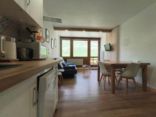 a kitchen and dining room with a table and chairs at Appart 4/6 pers pied des pistes La Mongie in Bagnères-de-Bigorre