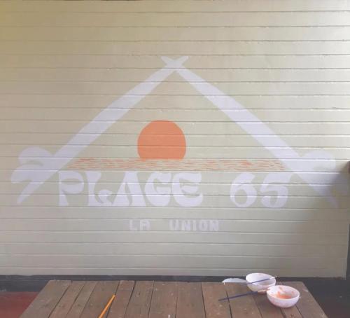 a garage door with a sign that says rise up in union at Plage 65 in San Juan