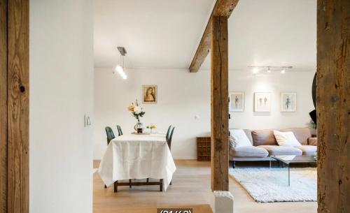 a living room with a table and a couch at The old bakery in Sandviken in Bergen