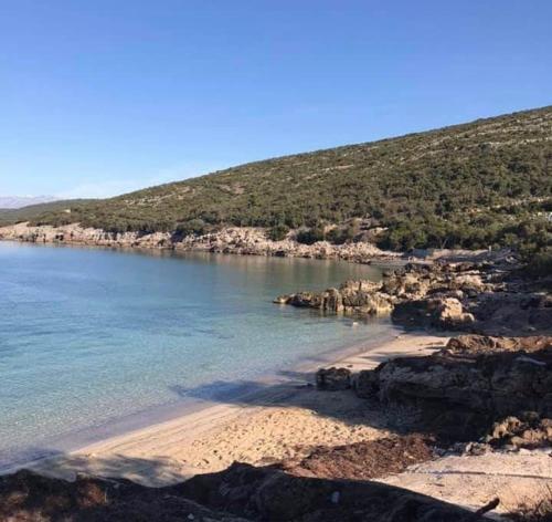 a view of a beach with rocks and the water at Villa Symphony apartments Kotor Tivat in Kotor