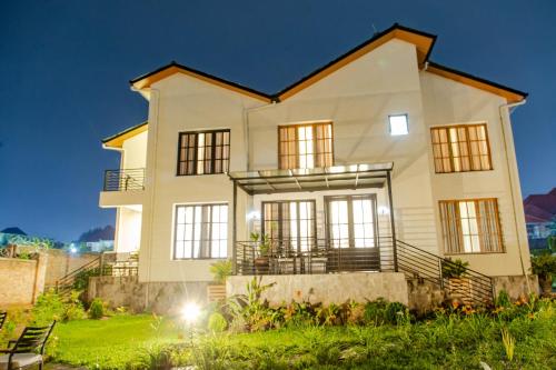 a large white house at night at Kwetu Villas Musanze in Ruhengeri