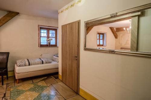 a hallway with a mirror and a couch in a room at Pension Casa Luciko in Brachwitz