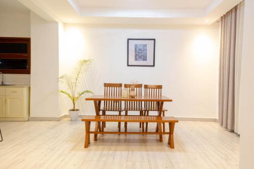 a living room with a bench and a table at Kwetu Villas Musanze in Ruhengeri