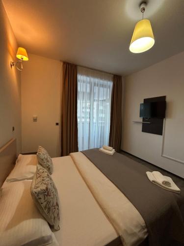 a hotel room with a bed and a window at Mountain Nest in Silver Mountain Poiana Brasov in Poiana Brasov