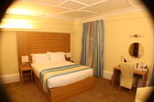 A bed or beds in a room at iSleep at The Drake 