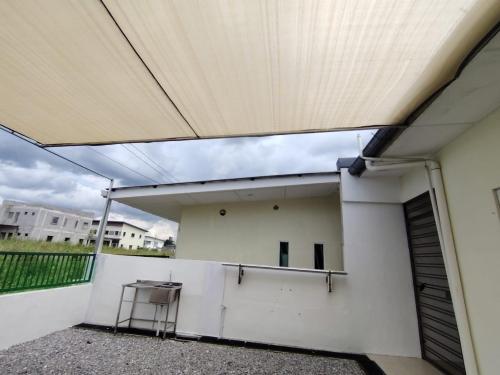 a view from the inside of a building with awning at pen kyu house1 in Kota Samarahan