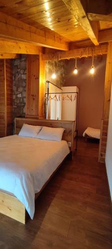 a bedroom with a large bed in a room at Vila Nikol in Voskopojë