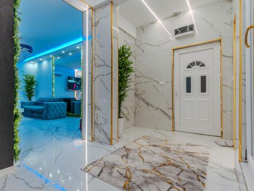 a lobby with a white door and a blue ceiling at Panorama Villa House Sarajevo- Jacuzzi, Bazen & Pogled na Grad 2 in Petruše
