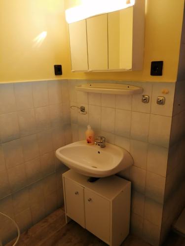 a bathroom with a sink and a mirror at Tulman Apartment in Balatonberény