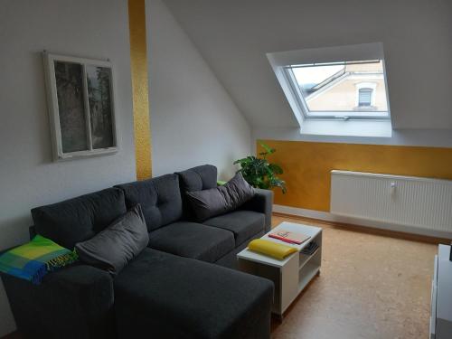 a living room with a couch and a window at Ferienwohnung im roten Haus, die Therme ist fußläufig in 350m zu erreichen in Bad Ems