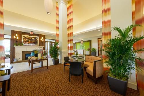 a lobby with potted plants in a hotel at Hilton Garden Inn Exton-West Chester in Exton