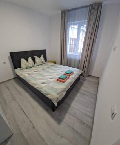 a bedroom with a large bed with a large window at myHome Residence in Nazna
