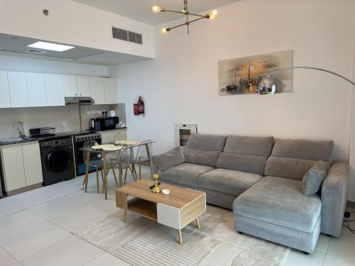 a living room with a couch and a table at Sleek 1BR in DSO, Dubai in Dubai