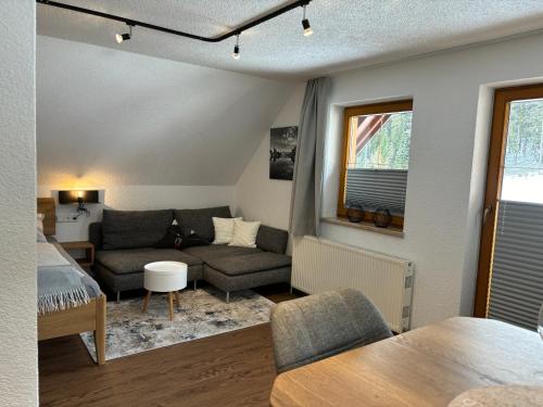 a living room with a couch and a bed and a table at Haus Sonnleitner Studio Rittisberg in Ramsau am Dachstein