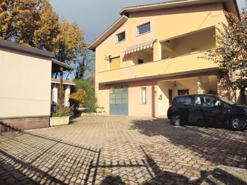 a car parked in front of a house at Appartamento Colle Di Roio in LʼAquila