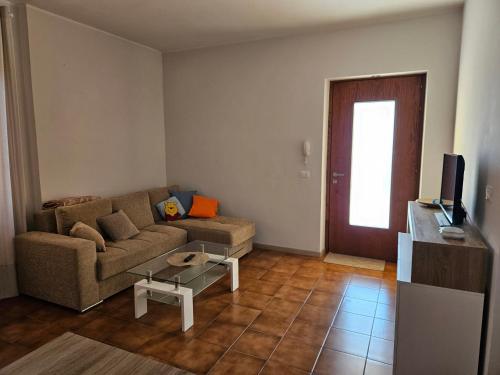 a living room with a couch and a table at Appartamento Colle Di Roio in LʼAquila
