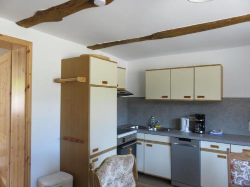 a kitchen with white cabinets and a counter top at Ferienhaus Diana in Thale