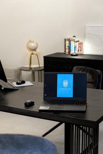 a laptop computer sitting on top of a table at La Madeleine Oia in Oia