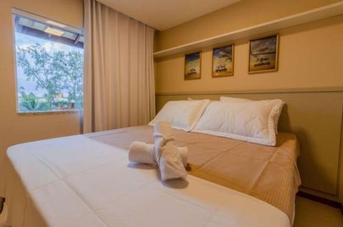 a bedroom with a large bed with towels on it at Casa Itacimitim Praia do Surf in Camacari