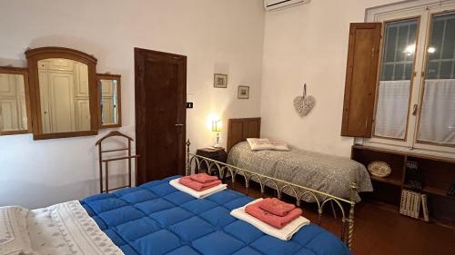 a bedroom with two beds with blue sheets in it at B&B Le 5 Vie Appartamento con camera tripla in Florence