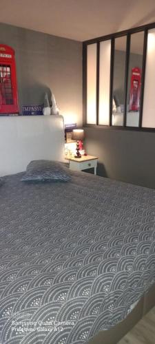 a bedroom with a large bed and a table at Le Relais de Chassepierre in Chassepierre