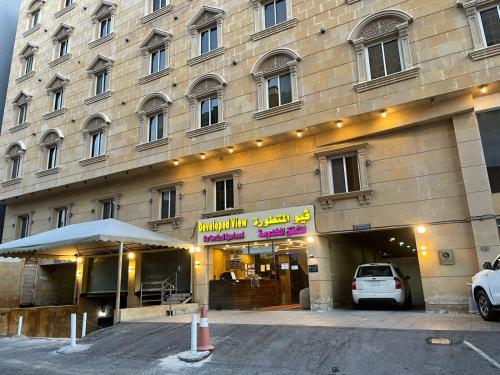 a large building with a car parked in front of it at Developed view Hotel in Jeddah
