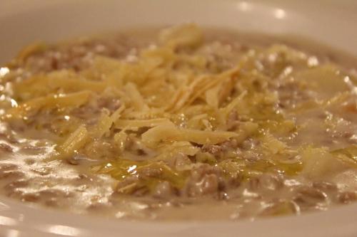 a white bowl of food with pasta and cheese at Agriturismo La Valle del Vento Urbino in Urbino