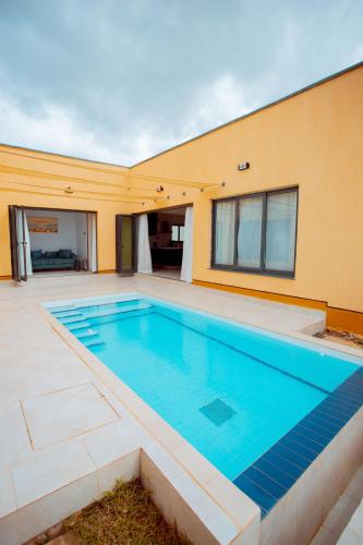 a swimming pool in the backyard of a house at Phelgone Nanyuki in Nanyuki