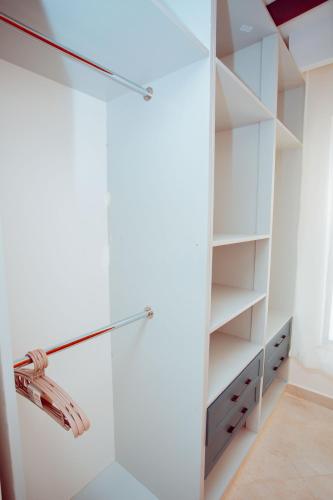 a white walk in closet with a glass door at Phelgone Nanyuki in Nanyuki