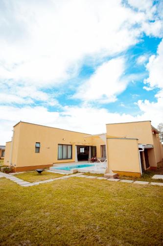 a house with a pool in front of it at Phelgone Nanyuki in Nanyuki