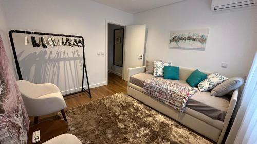 a living room with a couch and a chair at River View apartment in Chaves