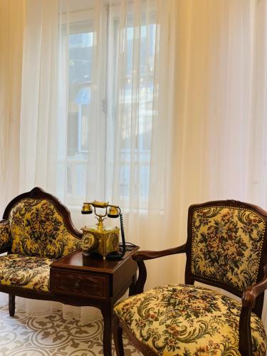 a room with a chair and a table with a telephone at Beehive Hotel and CoWorking in Varna City