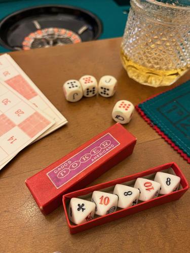 a table with dice and dominoes on it at Beehive Hotel and CoWorking in Varna City