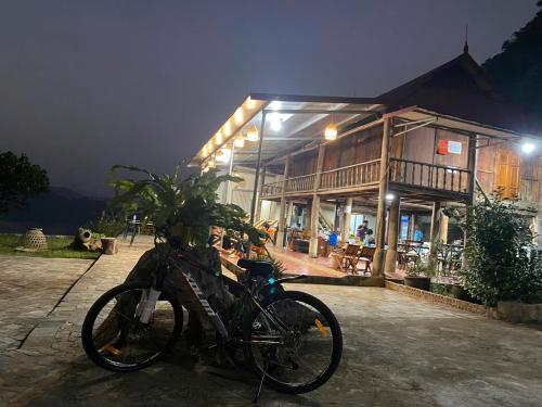 two bikes parked in front of a building at night at Nắng Village in Hòa Bình