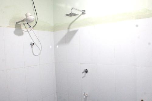 a bathroom with a shower with a shower head at Sigiriya Nature View home Stay in Sigiriya