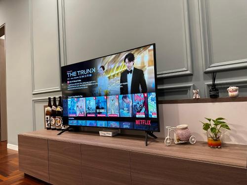 a flat screen tv sitting on top of a entertainment center at Bloomsvale Residence in Kuala Lumpur