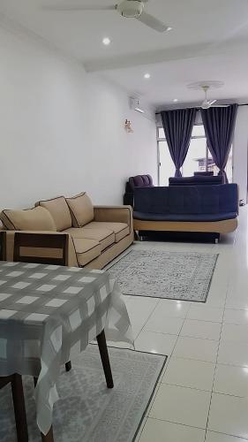 a living room with a couch and a table at AMAN Homestay Senawang musliim only in Senawang