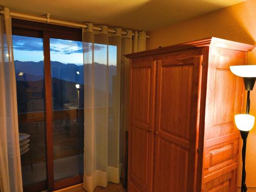 a room with a large window and a glass door at Résidence Au Petit Chamois in Le Corbier