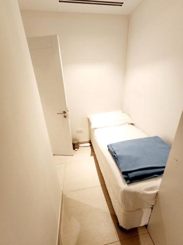 a small room with a bed and an open door at Solo RealtyHH Apartments - Address Residence Fujairah in Sharm