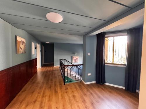 an empty room with a staircase and a window at Modern Studio N9 Kitchenette Bathroom in Limassol