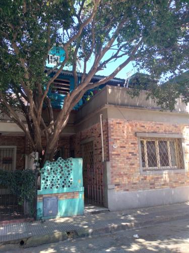 a brick building with a tree in front of it at Casa de botellas in Buenos Aires