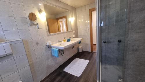 a bathroom with a sink and a shower at Appartements Kuprian in Längenfeld