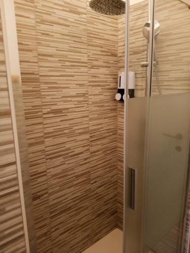 a shower with a glass door in a bathroom at Eros casa in Milan