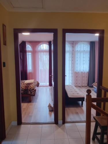 an open door to a living room with a couch at Mazsola Vendégház in Tamási