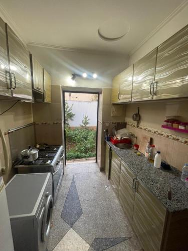 a small kitchen with a stove and a sink at Achraf Immo in Fez